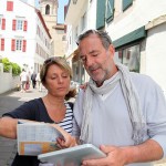 Mature couple in seaside resort looking at map